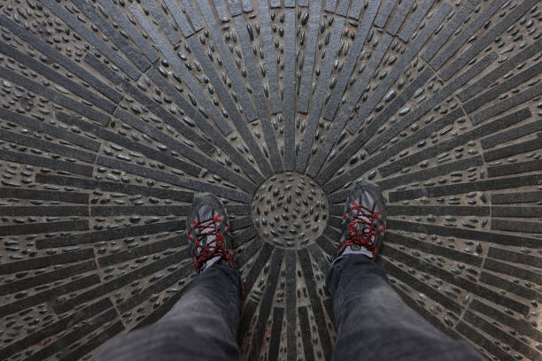 Feet standing on the geometric metal