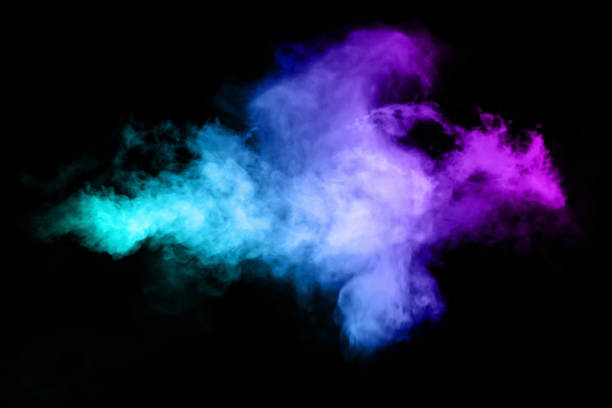 Multicolor powder explosion on black background. stock photo