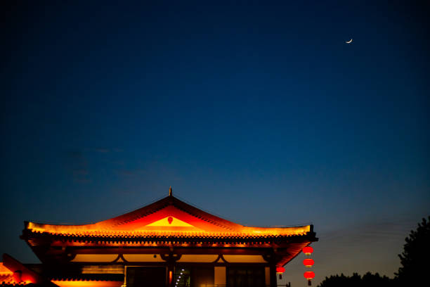 istock Red light up on the Chinese temple under the crescent moon. 1494219162