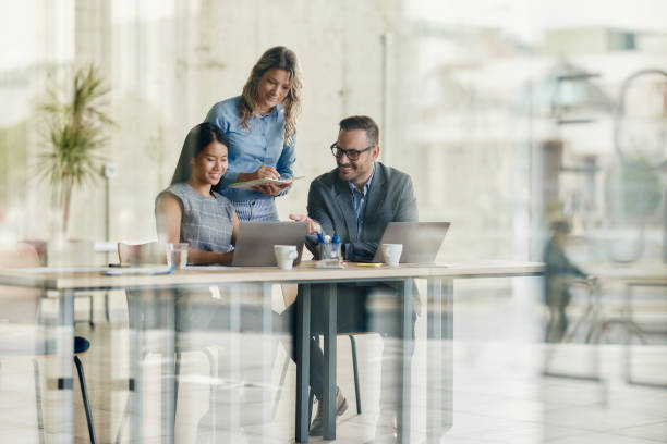 istock Happy business team working on laptop in the office. 1494220977