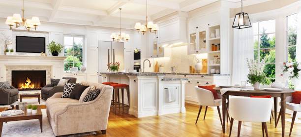 Luxurious white kitchen and living room with fireplace stock photo