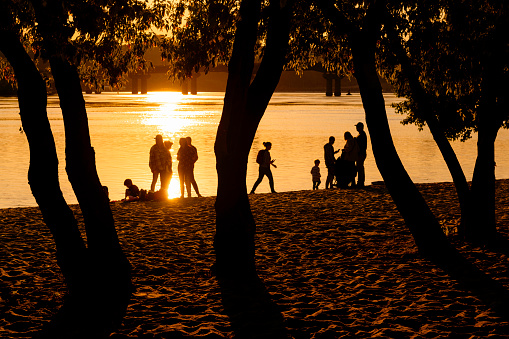 Kyiv. Ukraine, 21 May 2023, people chilling on a beach at sunset