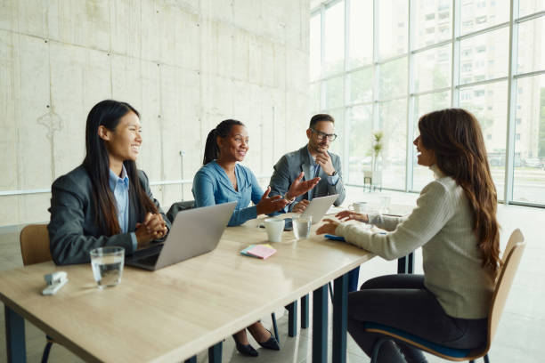 istock Mixed race human resource team talking to a candidate on a job interview. 1494221536