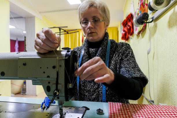 istock A woman is preparing a sewing machine for work. 1494222490