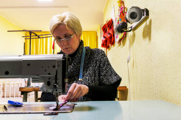 istock A woman tailor is preparing a sewing machine for work. 1494223419