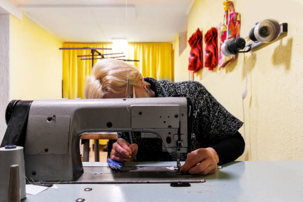 istock A woman at a tailored workshop is preparing for work on a sewing machine. 1494223552