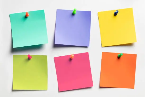 Photo of Group of colorful Sticky notes on white paper background