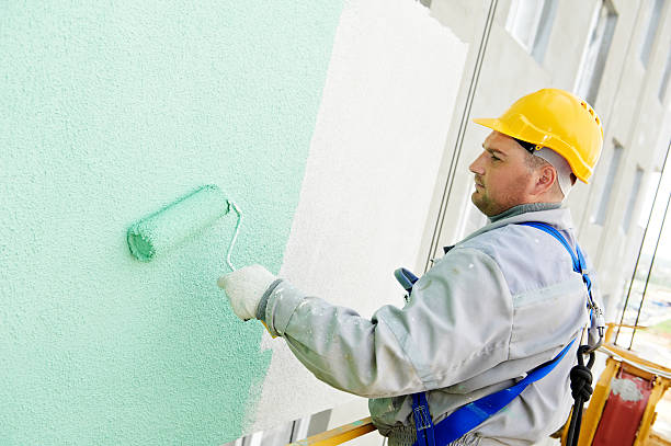 istock Construction worker painting building facade with green tone 149422501