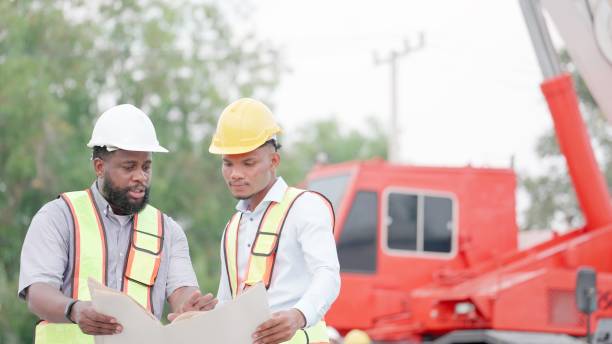 istock Construction manager in safety uniform have meeting with contractor, talking about details and construction progress construction of housing project at construction site. Concept of real estate business, building construction industry. 1494226342