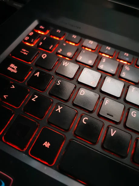 a computer keyboard with light stock photo
