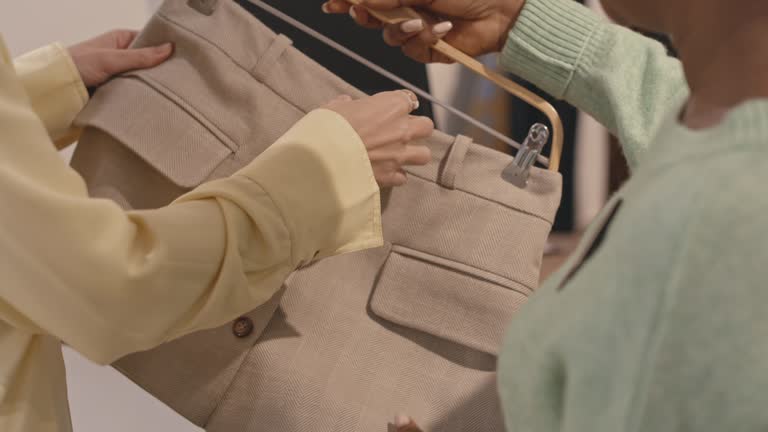 Woman Choosing Skirt in Designer Showroom