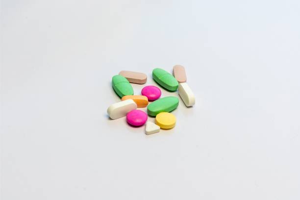 istock Colorful pills and tablets supplements on white isolated background 1494234480