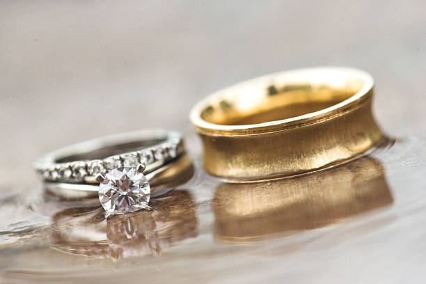 istock Husband and wife wedding rings on beach 1494234509