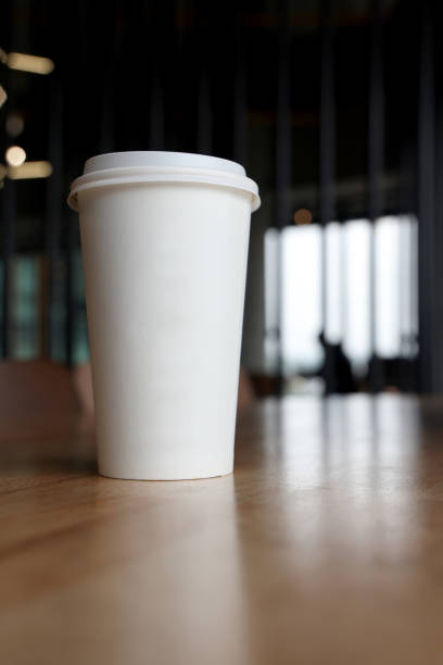 istock Coffee paper cup on wood table in coffee shop 1494236730