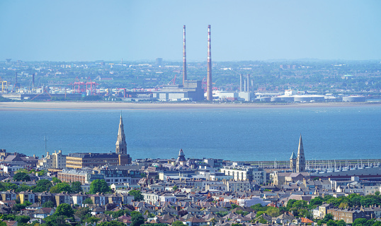 Dublin city skyline and bay, with Dun Laoghaire in the foreground, on a sunny summer day, and the Poolbeg chimneys in the distance