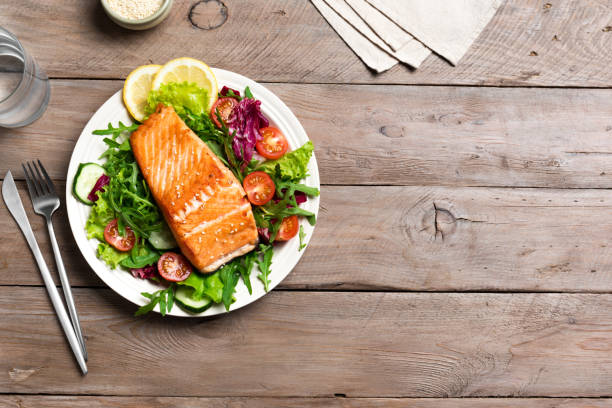 istock Grilled salmon fish fillet and vegetable salad 1494237556