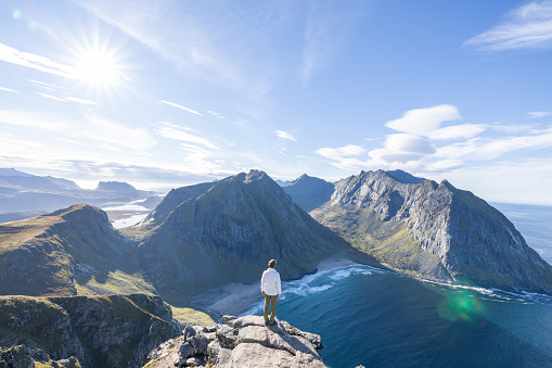 Young man hiking in a beautiful scenery in Summer enjoying nature and the outdoors.
Lofoten islands, Norway