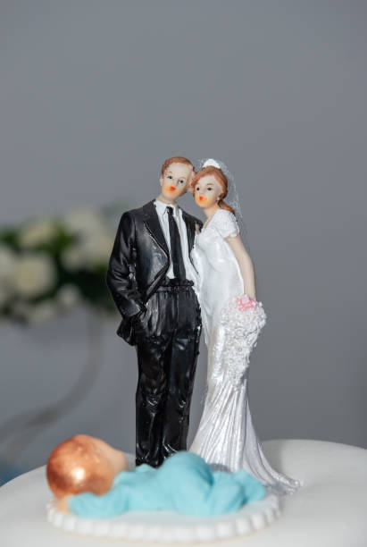 istock Bride and groom couple doll on wedding cake.miniature 1494240433