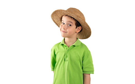 Studio shot of a cute little boy wearing a funky hat against a white background