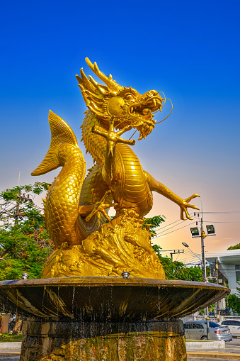 Golden dragon in old phuket town phuket Thailand this dragon is on the middle of a big water pond and fountain Chinese Dragon