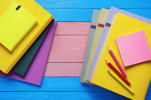 istock Bright books and colored pencils on rustic table. Flat lay. Copy space 1494245011