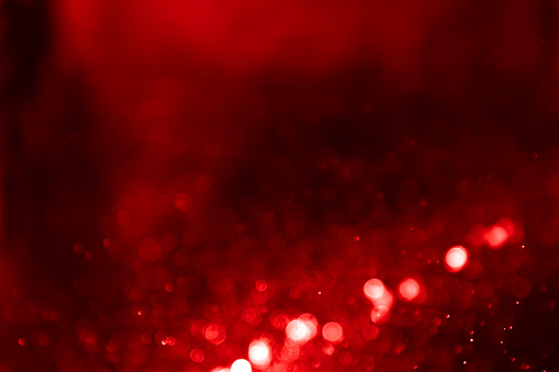 Abstract red gradient light defocus bokeh glitter background. Ideal as greeting card , Christmas and wedding celebration theme , valentines  etc.,