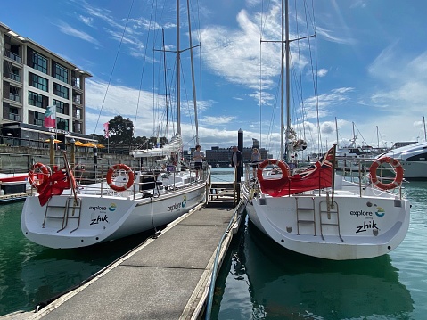 auckland, New Zealand – October 25, 2022: The two sailboats are securely tied up in a marina dock, surrounded by a calm body of water.