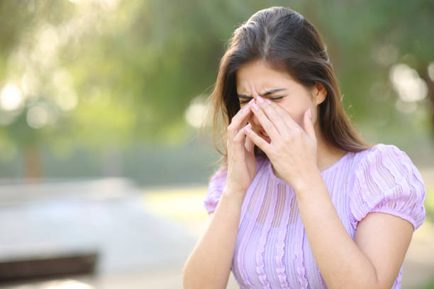 istock Allergic woman scratching eyes in a park 1494245712
