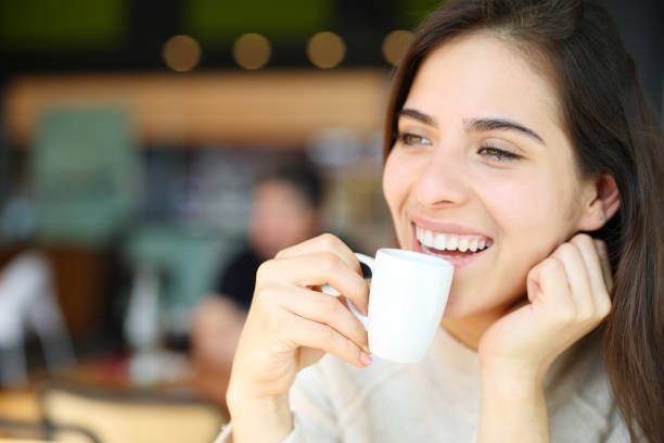 istock Happy woman drinking coffee and laughing 1494247356
