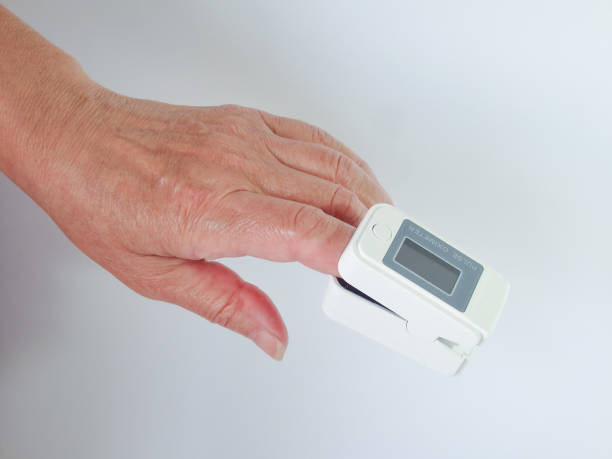 istock Woman using modern fingertip pulse oximeter on light background, closeup. Woman Uses Pulse Oximeter 1494247601