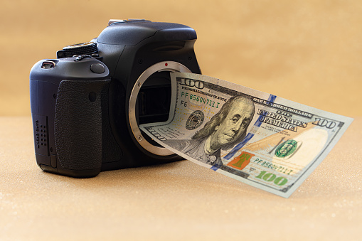US 100 dollar banknote and photo camera for design purpose