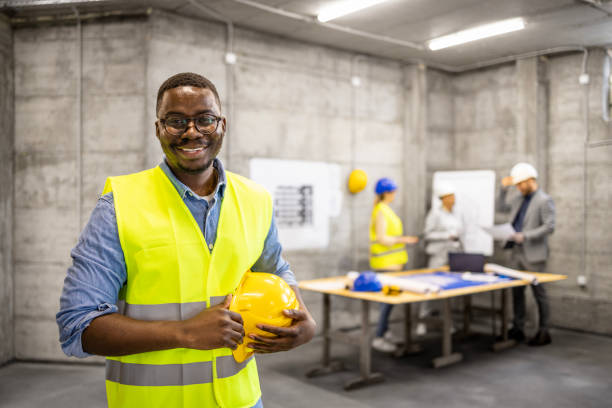 istock Portrait of Afro - American construction engineer standing inside building site. 1494248194