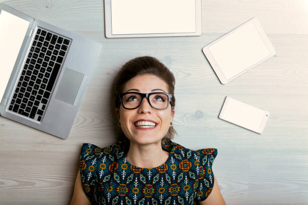 istock Joyful woman among four empty screen devices 1494249240
