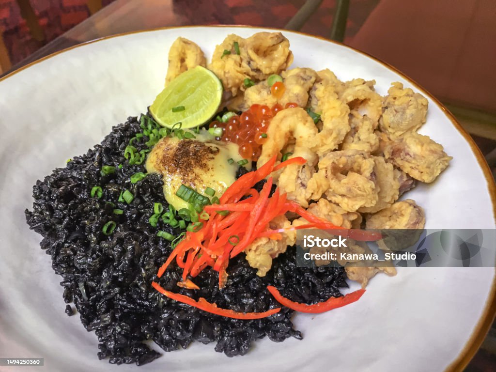 Black Rice Squid Ink With Crunchy Calamari Stock Photo - Download Image