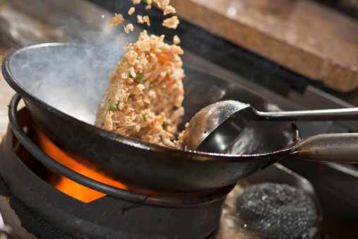 Closeup of fried rice being cooked in wok