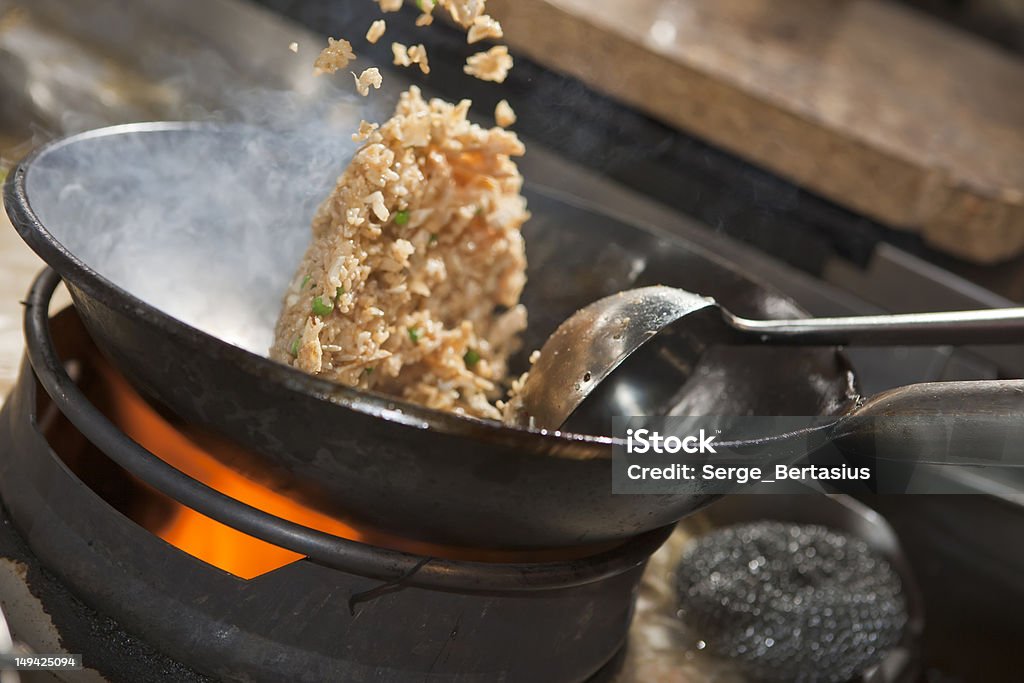 Close-up of Asian stir-fry cooking in a wok Closeup of fried rice being cooked in wok Fried Rice Stock Photo