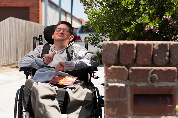 Young Man getting his Mail Young Man getting his Mail, seated in his wheelchair. developmental disability stock pictures, royalty-free photos & images