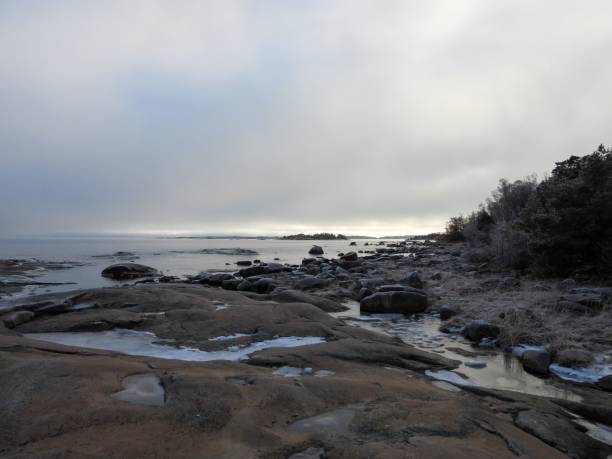 istock a rocky shore has ice melting from the water on it 1494255381