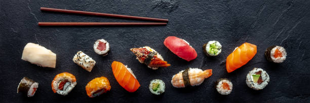 istock Sushi overhead flat lay panorama with chopsticks. Rolls, maki, nigiri 1494257186