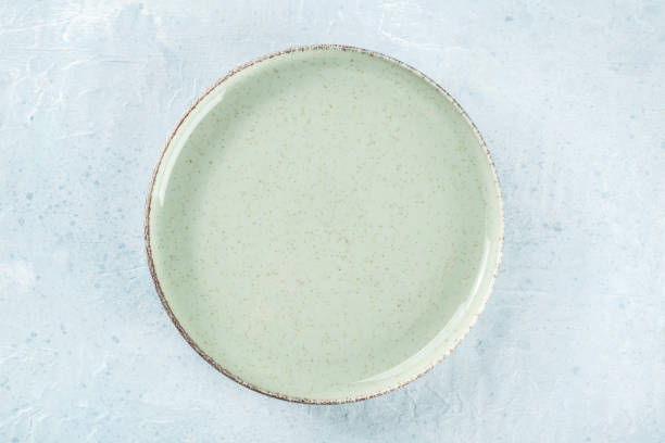 istock An empty green plate, overhead flat lay shot on a slate background 1494257281