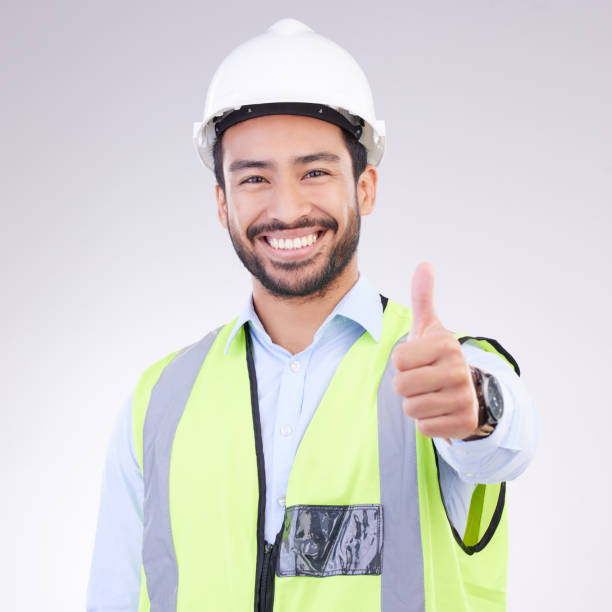 istock Thumbs up of engineering man face isolated on a white background support, like or success in project management goals. Asian construction worker or architect contractor  thank you hand sign in studio 1494257376