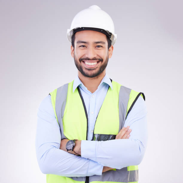 istock Construction worker in portrait, man with crossed arms and smile, architect or engineer in building industry on studio background. Happy male contractor, mockup and professional builder with helmet 1494257377