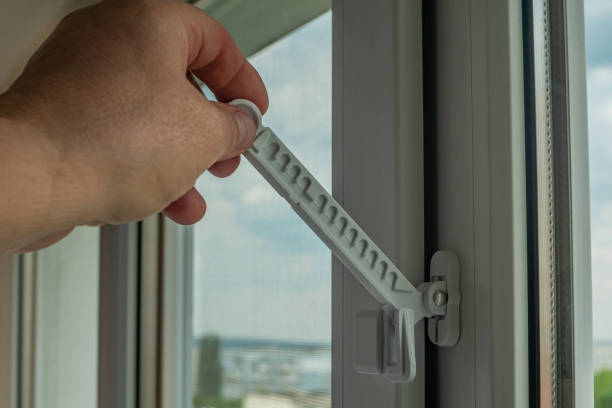 istock Master installed fixing limiter for opening a plastic window and checks its operation. Close-up of a hand checking the operation of window fittings. Home repairs. Installing window hardware 1494257474
