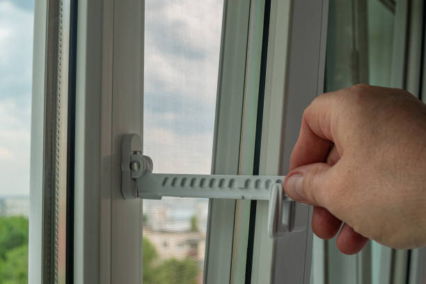 istock Master installed fixing limiter for opening a plastic window and checks its operation. Close-up of a hand checking the operation of window fittings. Home repairs. Installing window hardware 1494257509