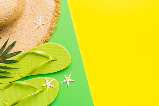 Summer vacation concept flat lay. straw hat beach accessories and flip flop top view. Space for text. travel concept.