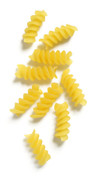 Rotini or Corkscrew Pasta on White Background Dry rotini (or corkscrew) pasta isolated on 255 white. fusilli stock pictures, royalty-free photos & images
