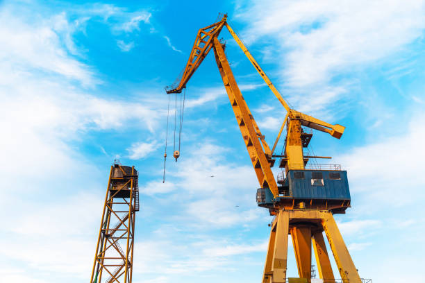 istock Harbor crane on a background of blue sky, bottom view. 1494260028