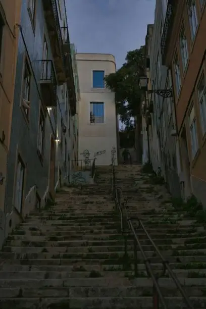 A cobblestone stairway, with a narrow walkway, leading up to two buildings