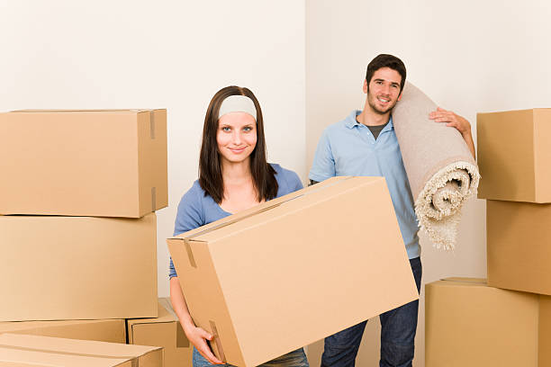 istock Home moving young couple boxes and carpet 149426204