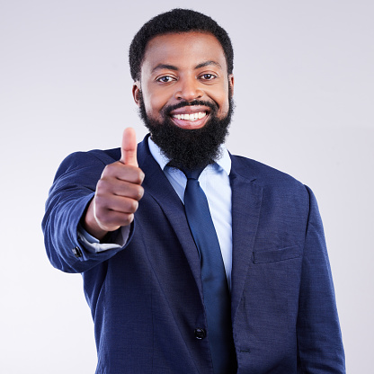 Thumbs up, business portrait and happy black man in studio for yes review, thank you and trust. Corporate male, model and thumb gesture for support, like emoji and motivation of agreement, ok or vote